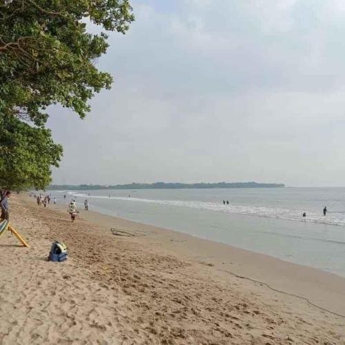 a group of people on a beach with the ocean at Lippo Carita 9270 in Carita