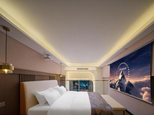 a bedroom with a bed and a poster of a ferris wheel at Ouchen International Sky River Hotel (Monument to the people's Liberation Pedestrian Street Store, Chongqing) in Chongqing