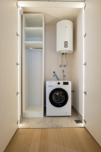 a laundry room with a washer and dryer at Zepterme Spa&Wellness Luxury Apartments member of Zepter hotels in Vrnjačka Banja