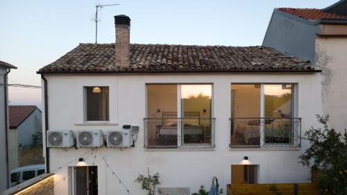 a white house with windows and a roof at Dimora 59 in Santa Maria Imbaro