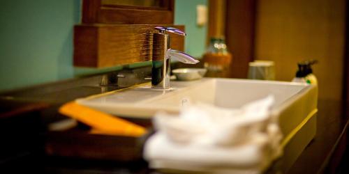 a bathroom sink with a faucet on a counter at Sibsan Resort & Spa Maetaeng Chiang Mai in Mae Taeng
