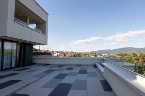 a balcony with a view of the mountains at Zepterme Spa&Wellness Luxury Apartments member of Zepter hotels in Vrnjačka Banja