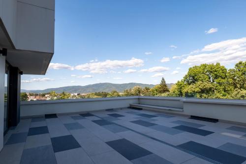 a balcony with a view of the mountains at Zepterme Spa&Wellness Luxury Apartments member of Zepter hotels in Vrnjačka Banja