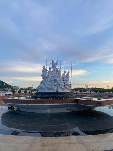a statue in a parking lot in front at Hà Tiên Hạnh Phúc Hotel in Ha Tien