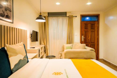 a hotel room with a bed and a chair at Qusini Studio Suite in Nairobi
