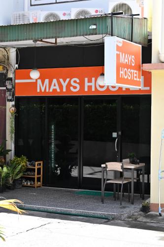 a building with a sign that says mayneys hospital at Mays Hostel in Hua Hin