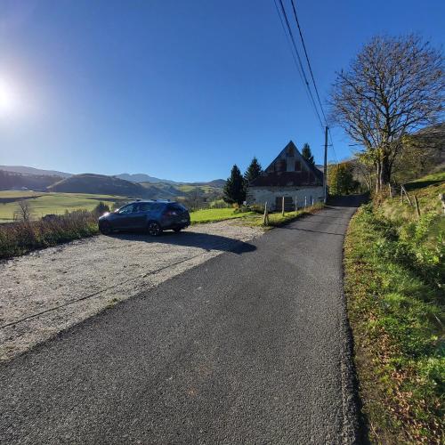 a car parked on the side of a road at La Grange d'Olivier in Le Claux