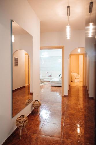 a living room with a mirror and a couch at Luxury Suite Prada in Paleokastritsa
