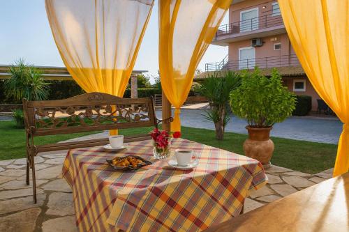 a table with a plate of food on top at Cozy flats in an olive grove by the sandy beach in Kánalos