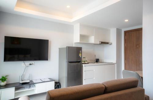 a living room with a couch and a refrigerator at Parc21 Luxury Boutique Hotel in Phnom Penh