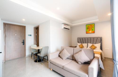 a living room with a couch and a bed at Parc21 Luxury Boutique Hotel in Phnom Penh