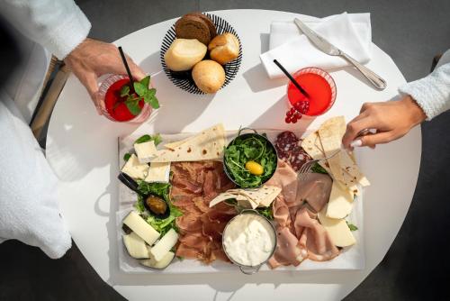 a white table with a variety of food on it at Bolina Suite & Spa in Milano Marittima