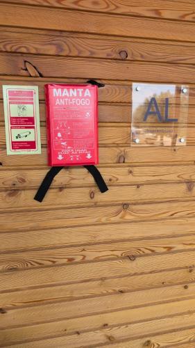 a red book is hanging on a wooden wall at Bungalow Quinta Sete Charós in Nisa