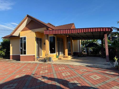 a house with a red roof and a brick driveway at HB Warisan Homestay in Kota Bharu