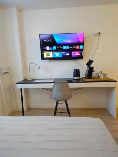 a desk with a computer monitor on a wall at L'Iliade 2 in Grenoble