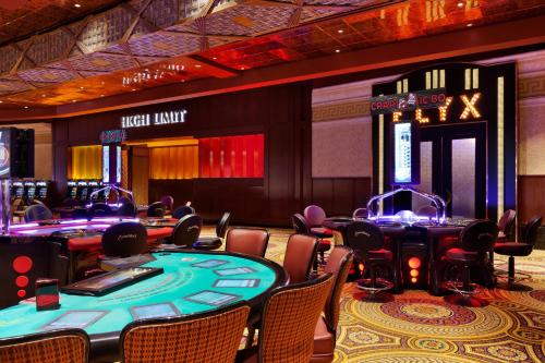 a casino with poker tables and chairs in a room at Caesars Windsor Hotel and Casino in Windsor