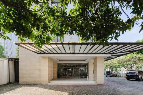 a building with awning on the side of it at Sans Vibes Firdaus Mansion Kemang in Jakarta