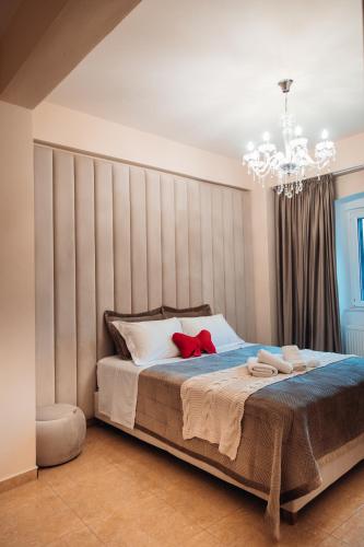 a bedroom with a large bed with a chandelier at Luxury Suite Prada in Paleokastritsa