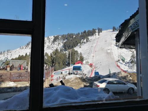 a view of a ski slope from a window at Samson Inn in Dargai