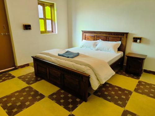 una camera da letto con un letto grande con testiera in legno di Garh Madan Heritage Hotel a Jodhpur