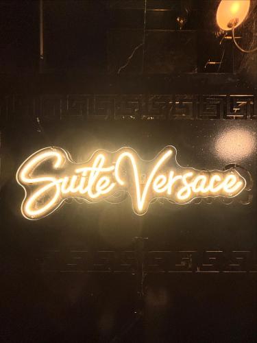 a neon sign that says suite versace at night at Suite Versace in Montpellier