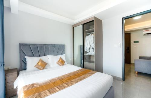 a bedroom with a large bed and a couch at Parc21 Luxury Boutique Hotel in Phnom Penh