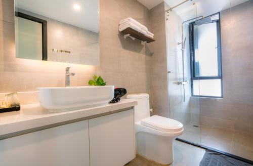 a white bathroom with a sink and a toilet at Parc21 Luxury Boutique Hotel in Phnom Penh