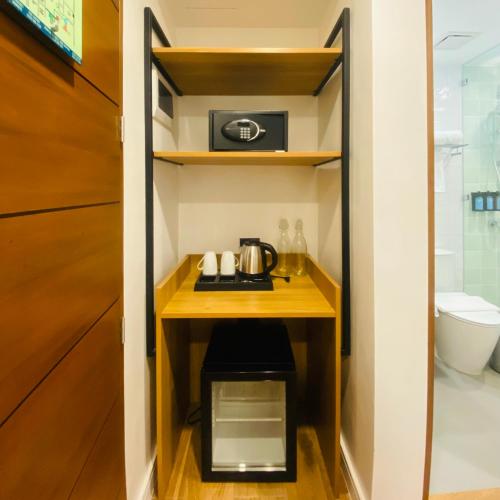 a small cabinet in a bathroom with a tea kettle on it at V Boutique Hotel Boracay in Boracay
