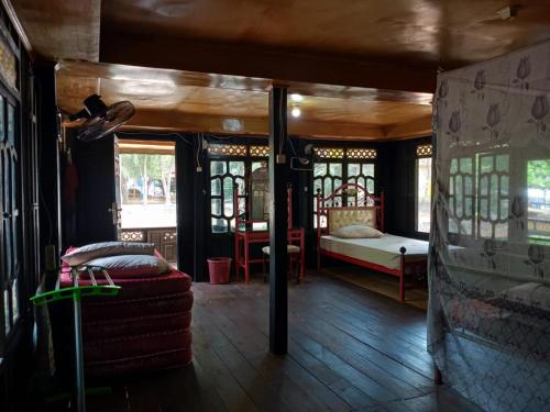a bedroom with a bed and windows in a room at The Norsyah Villa selayar in Pareangang