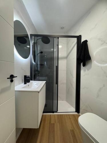 a white bathroom with a shower and a sink at Apartamento - 2HAB - 4PAX - Platería - Murcia in Murcia