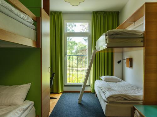 a room with two bunk beds and a window at Bosön Hotell & Konferens in Lidingö