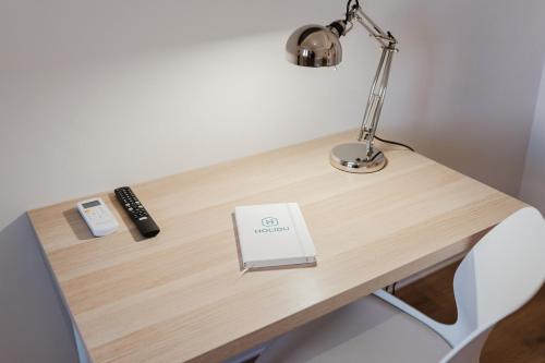 a desk with a lamp and a book on it at Ardesia Vacanze in Valderice