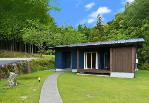 a small blue house with a grassy yard at Class Besso Ise - Vacation STAY 61647v in Iseji