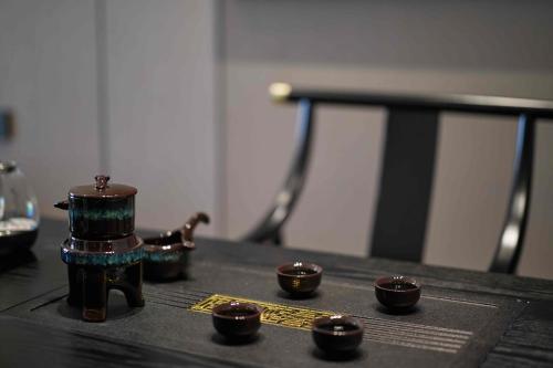 a table with four small cups on top of it at 西双版纳熙源国际酒店 in Jinghong