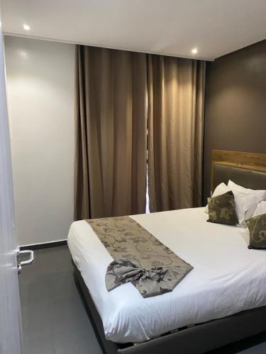 a bedroom with a large bed with a white bedspread at Prime Hotel in Northwich