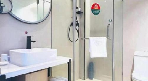 a bathroom with a sink and a shower at GreenTree Inn Langfang Sanhe South Yingbin Road Express Hotel in Sanhe