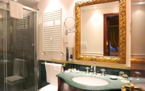 a bathroom with a sink and a mirror at Hotel Colombina in Venice