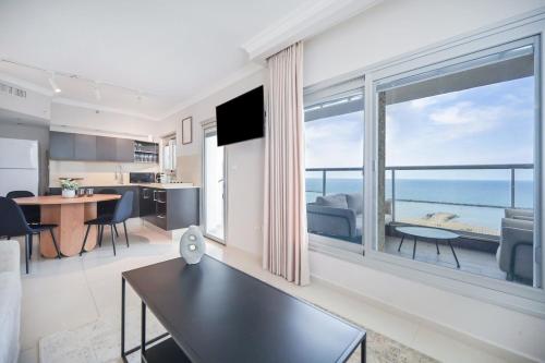 a living room with a view of the ocean at Orchid Hotel by HolyGuest in Tel Aviv