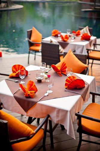 a group of tables with chairs and wine glasses at Sibsan Resort & Spa Maetaeng Chiang Mai in Mae Taeng