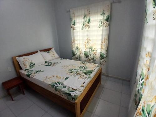 a small bed in a room with a window at Maitidi Place in Paramaribo
