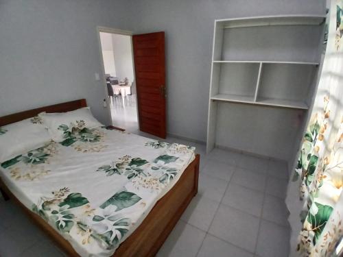 a bedroom with a bed and a book shelf at Maitidi Place in Paramaribo