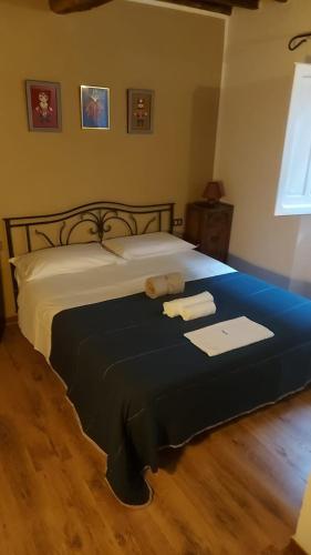 a bedroom with a bed with two towels on it at Alla Meria in Castiglione della Pescaia