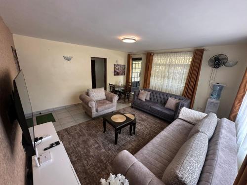 a living room with a couch and a table at Ecostay 3bedroom ground floor in Kisumu