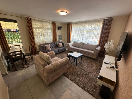 a living room with a couch and chairs and a table at Ecostay 3bedroom ground floor in Kisumu