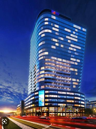 a tall building with a sign on the side of it at Hanza Tower 22 WHITE Jacussi & Sauna & Pool & SPA in Szczecin