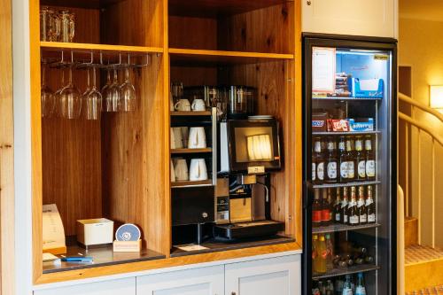a display cabinet with a coffee machine in a store at Landhotel Kauzenberg in Bad Kreuznach