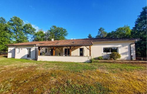 a small white house on a grassy field at Cozy Home In Sarliac With Wifi in Bujadelle