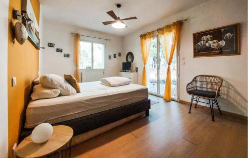 a bedroom with a bed and a table and a window at Cozy Home In Sarliac With Wifi in Bujadelle