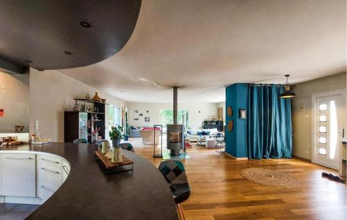 a kitchen and living room with a table in a room at Cozy Home In Sarliac With Wifi in Bujadelle