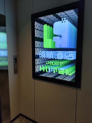 a flat screen tv on a wall in a room at Pilot Hotel in Chongqing